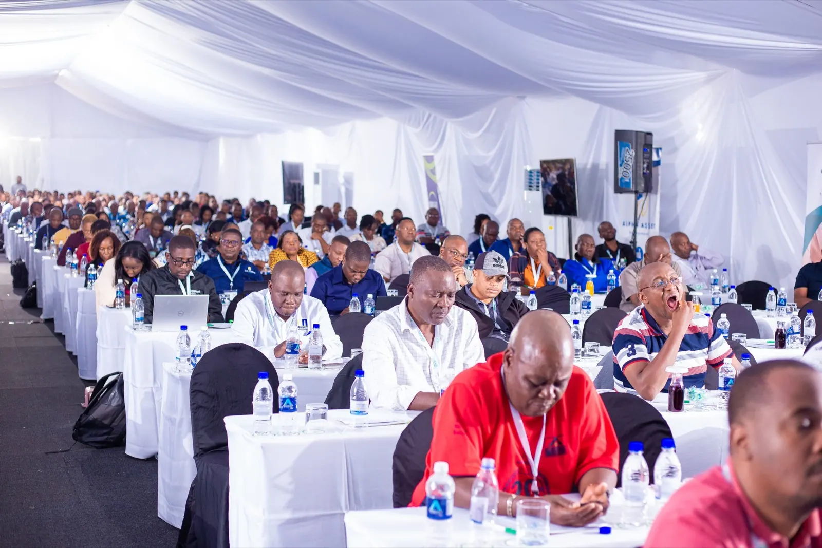 Delegates seated at long tables in a marquee during the 49th ZAPF Annual Conference