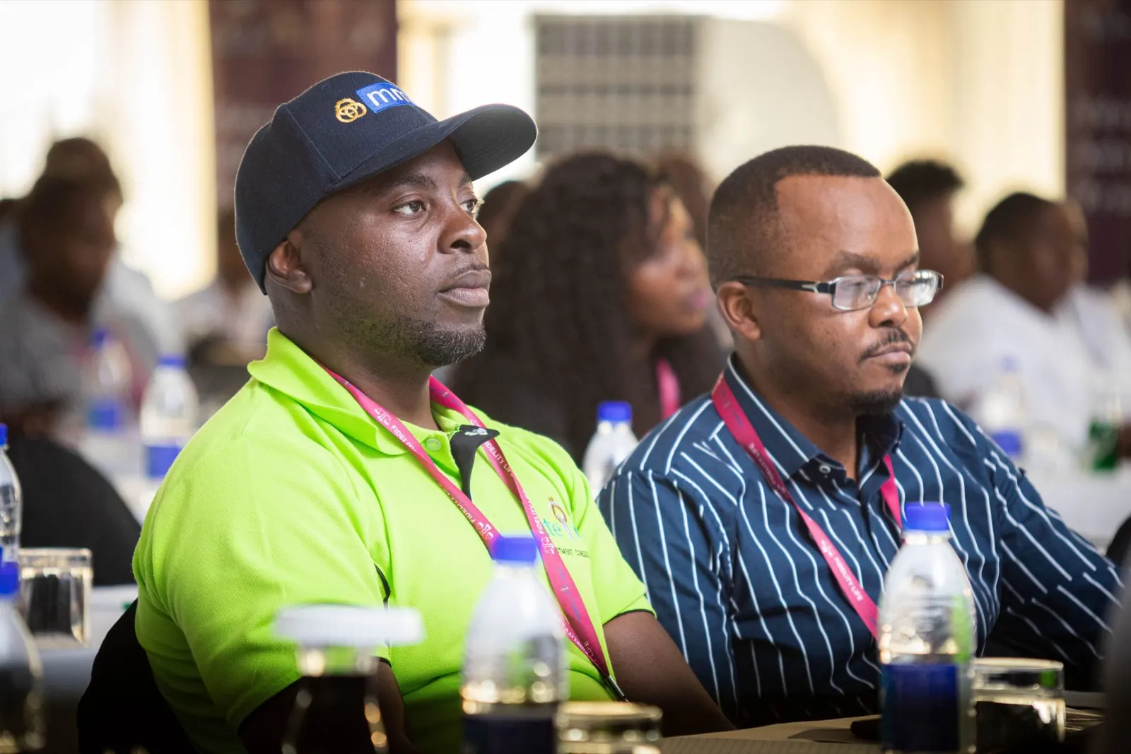 Two delegates follow a presentation at the Victoria Falls conference