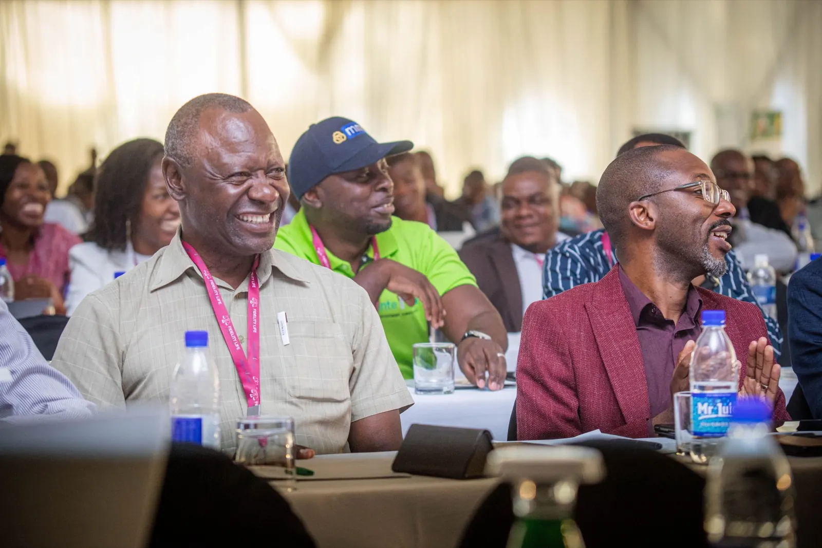 Delegates share a light moment during a conference session