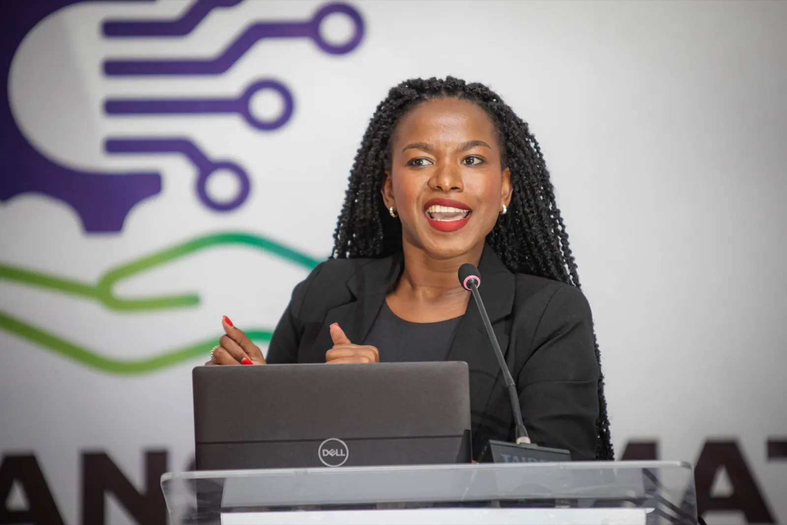 A presenter speaking from a laptop at the conference