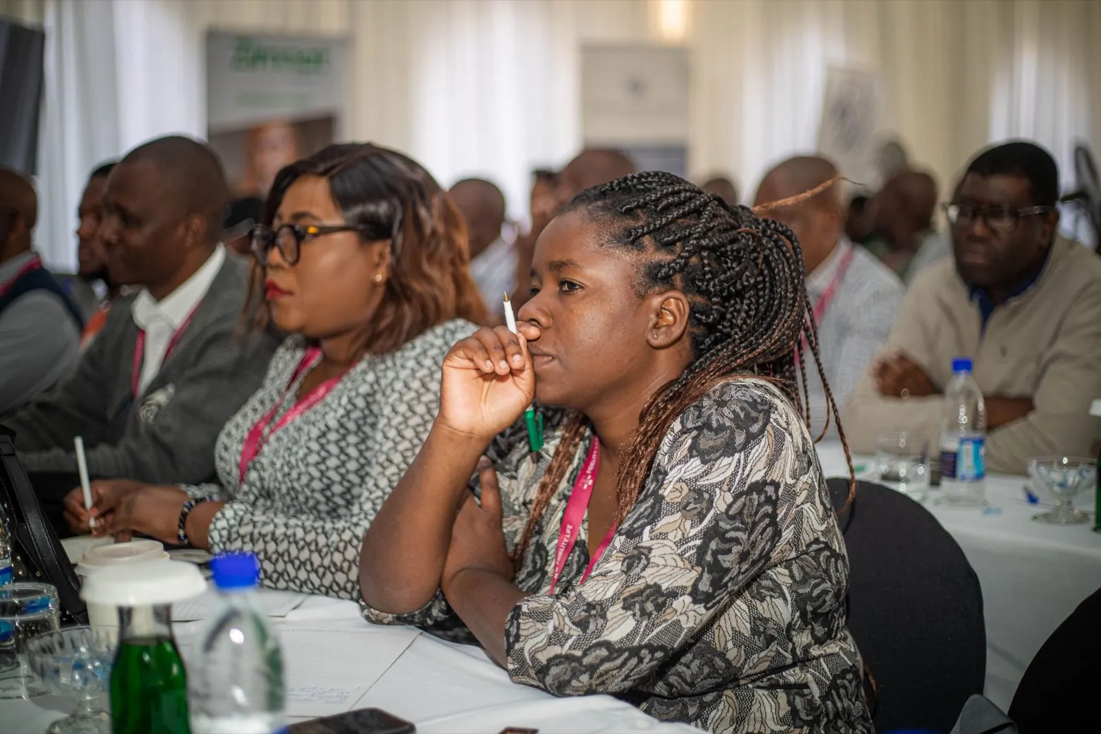 Women delegates listening during a conference session