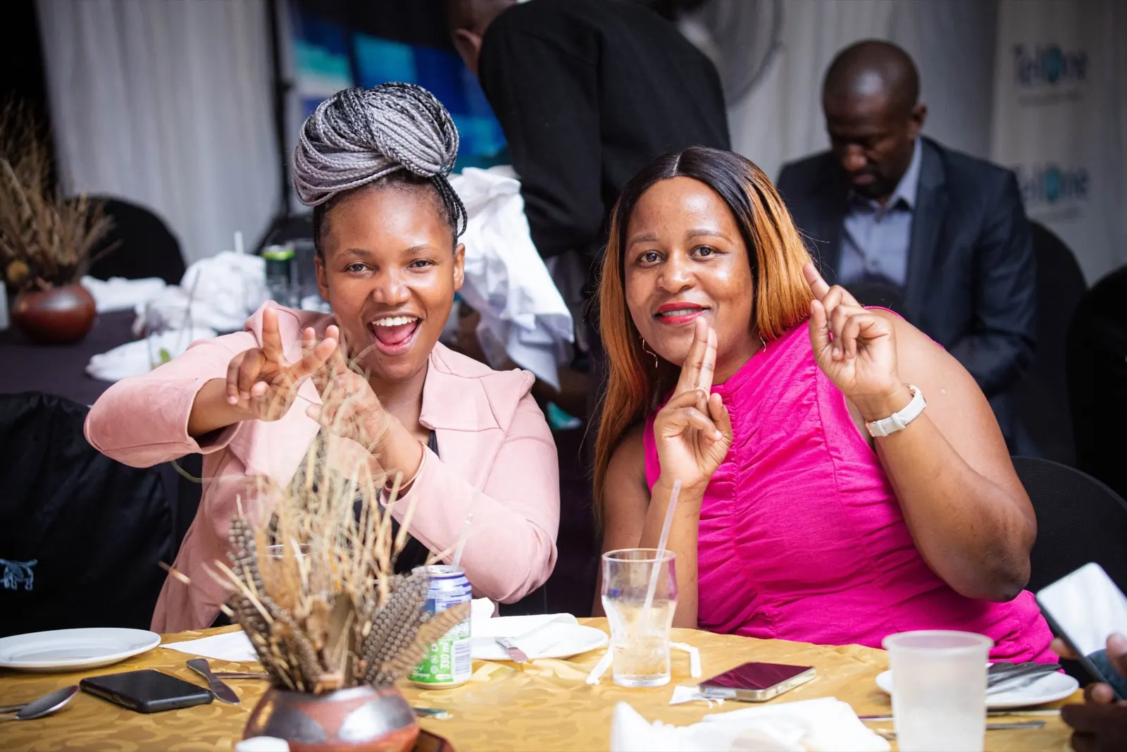 Two delegates laughing together at the gala dinner